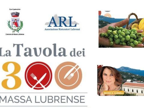 “Cena gourmet all’aperto durante l’evento La Tavola dei 300 a Massa Centro con ospiti e luci serali”